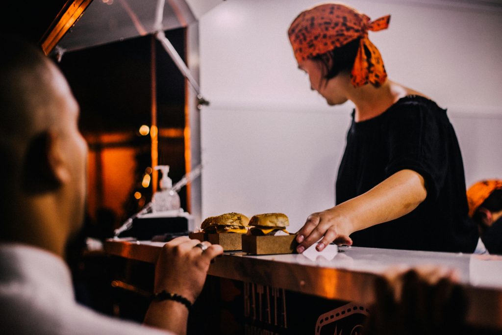 pexels photo 1247755 1247755 A street vendor in Maceio, Brazil serves burgers at a night market food stall.